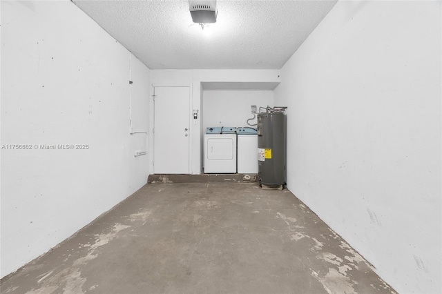 interior space featuring a garage, water heater, a textured ceiling, and separate washer and dryer