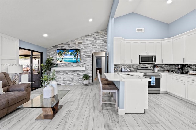 1222 Stardust Way, Royal Palm Beach, FL 33411 - kitchen with a sink, stainless steel appliances, high vaulted ceiling, visible vents, and open floor plan
