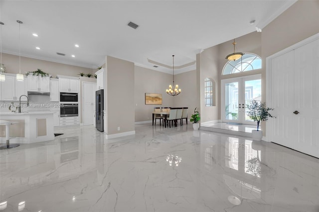 entryway featuring marble finish floor, french doors, visible vents, and crown molding