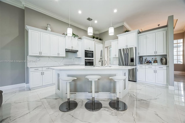 kitchen with marble finish floor, stainless steel appliances, light countertops, white cabinets, and under cabinet range hood