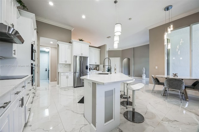 kitchen with arched walkways, marble finish floor, crown molding, appliances with stainless steel finishes, and under cabinet range hood