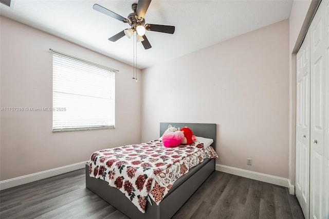 bedroom with a closet, ceiling fan, baseboards, and wood finished floors