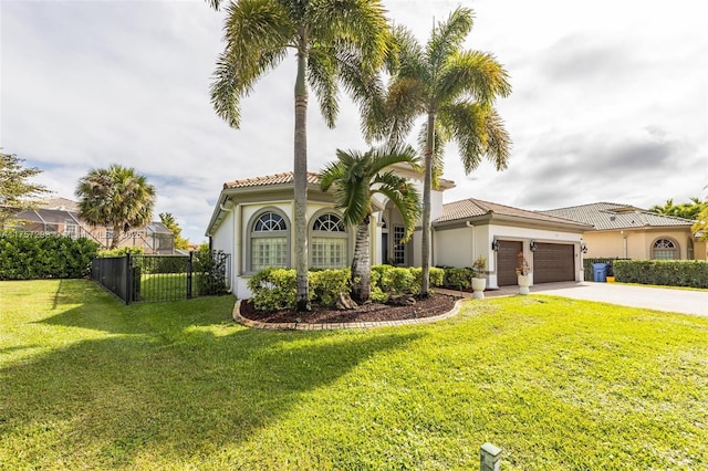 mediterranean / spanish-style house featuring a garage, driveway, fence, a front lawn, and stucco siding