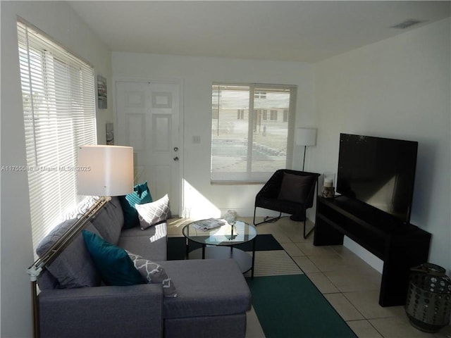 living room with light tile patterned floors and visible vents