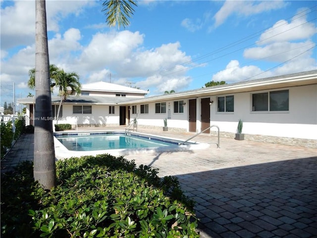 community pool featuring fence and a patio