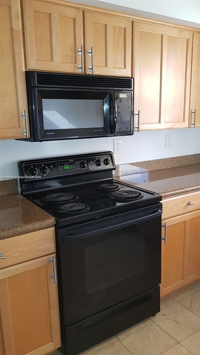 kitchen with black appliances and light brown cabinets