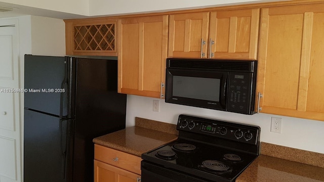 kitchen with black appliances and dark countertops