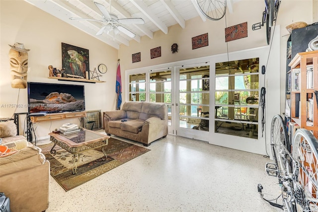 living room with ceiling fan, high vaulted ceiling, beamed ceiling, and speckled floor