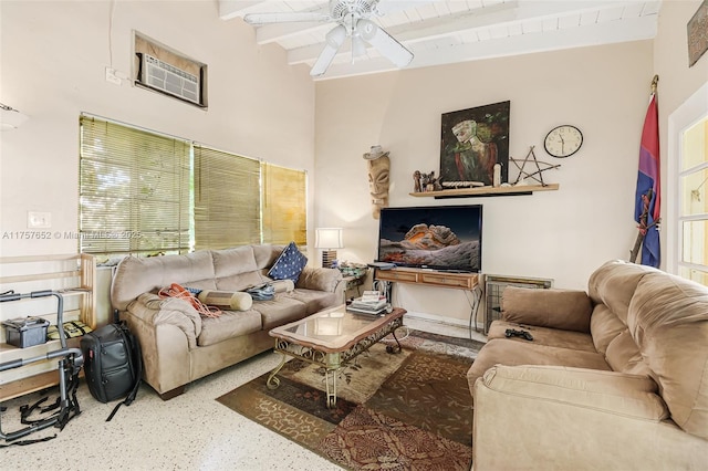 living room with speckled floor, beamed ceiling, and a ceiling fan