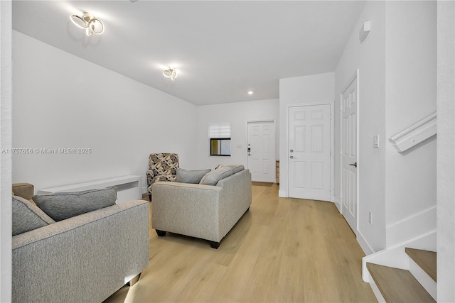 living area with baseboards and light wood-style flooring