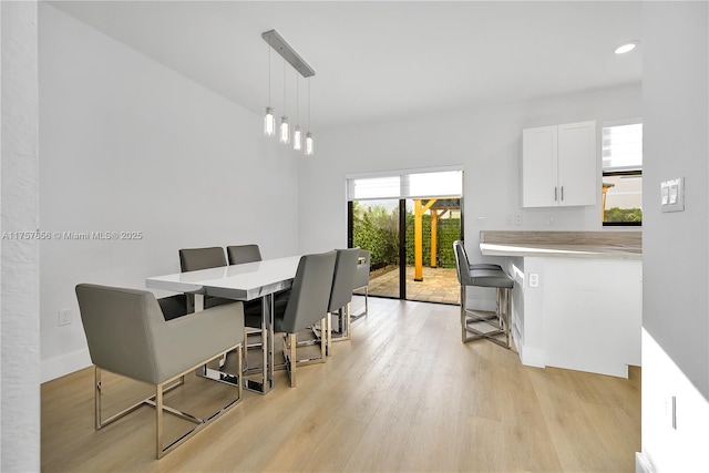 dining area featuring light wood finished floors