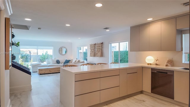 kitchen with light countertops, visible vents, modern cabinets, dishwasher, and a peninsula