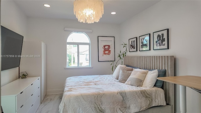 bedroom featuring recessed lighting, a notable chandelier, and baseboards