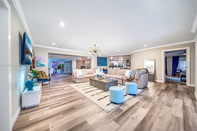 living room featuring ornamental molding, wood finished floors, and a notable chandelier