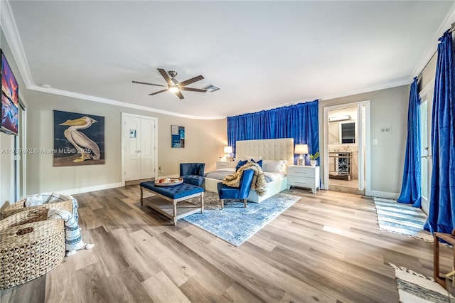 bedroom featuring ceiling fan, ornamental molding, wood finished floors, and baseboards