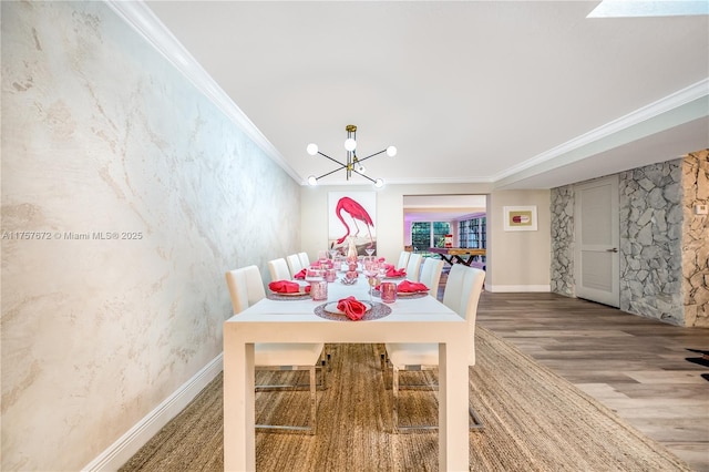 dining room with a chandelier, baseboards, wood finished floors, and crown molding