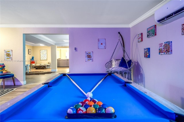 rec room with wood finished floors, billiards, baseboards, a wall mounted air conditioner, and crown molding