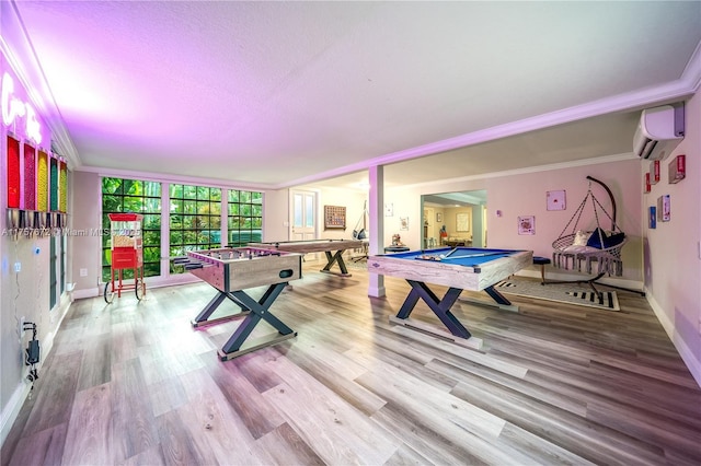 recreation room with wood finished floors, pool table, crown molding, and a wall mounted AC