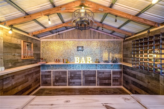 interior space with lofted ceiling and wooden walls