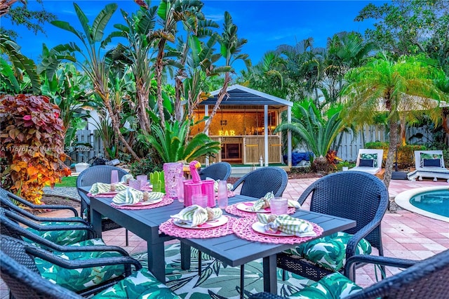 view of patio with outdoor dining space, a fenced backyard, and a gazebo