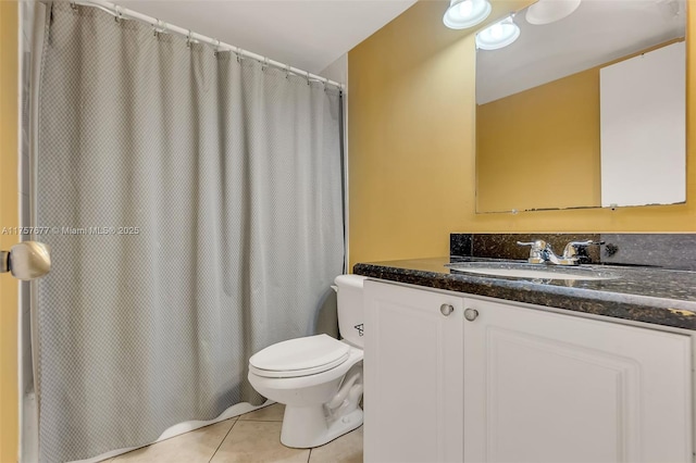 bathroom with curtained shower, vanity, toilet, and tile patterned floors