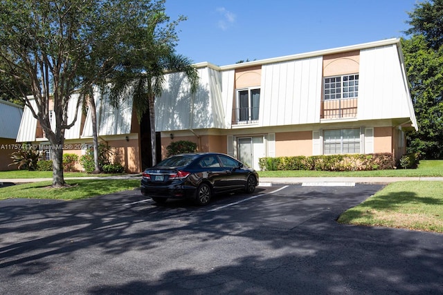 view of property featuring uncovered parking