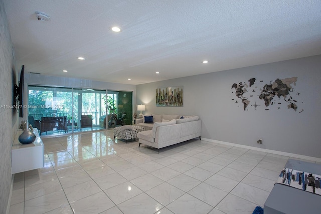 living area featuring baseboards, a textured ceiling, and recessed lighting