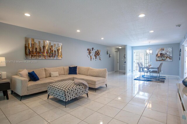 living room with a textured ceiling, light tile patterned floors, recessed lighting, and baseboards