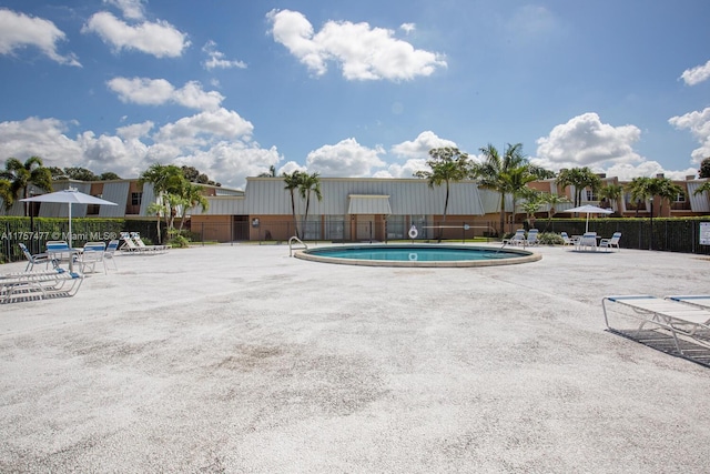 pool featuring a patio area and fence