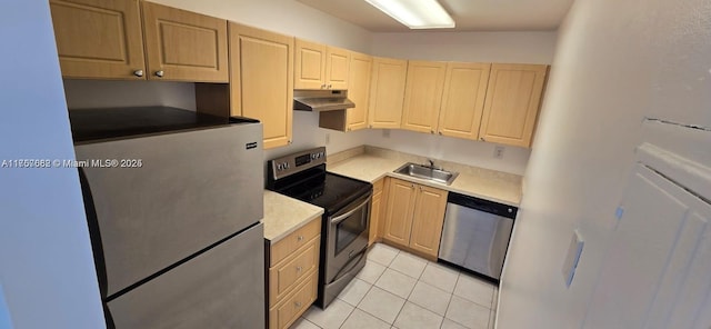 kitchen with appliances with stainless steel finishes, light brown cabinets, a sink, and under cabinet range hood