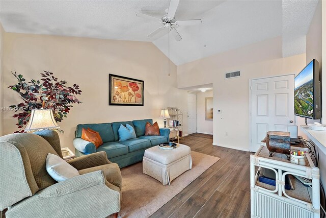 living room featuring visible vents, a ceiling fan, vaulted ceiling, wood finished floors, and baseboards