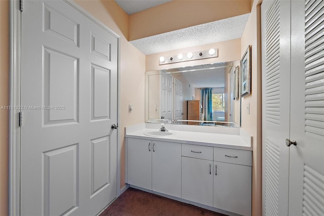 bathroom featuring a textured ceiling and vanity