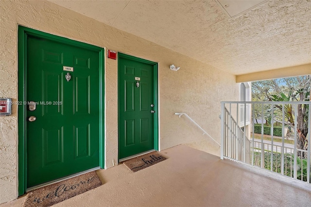 property entrance with stucco siding