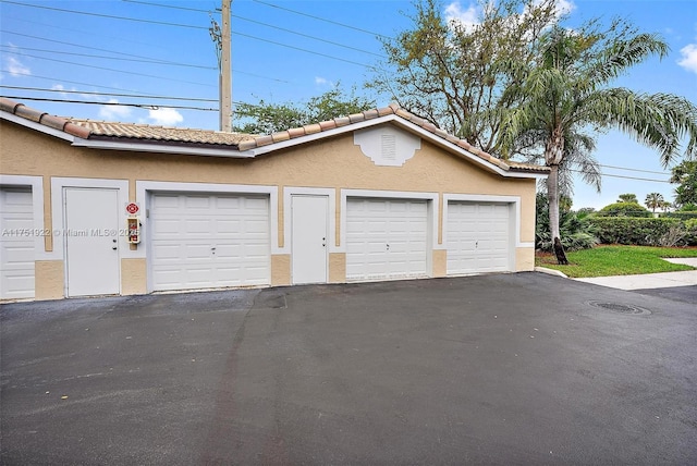 garage featuring aphalt driveway