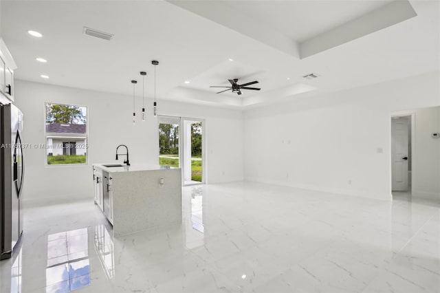 kitchen with recessed lighting, stainless steel appliances, visible vents, marble finish floor, and a raised ceiling