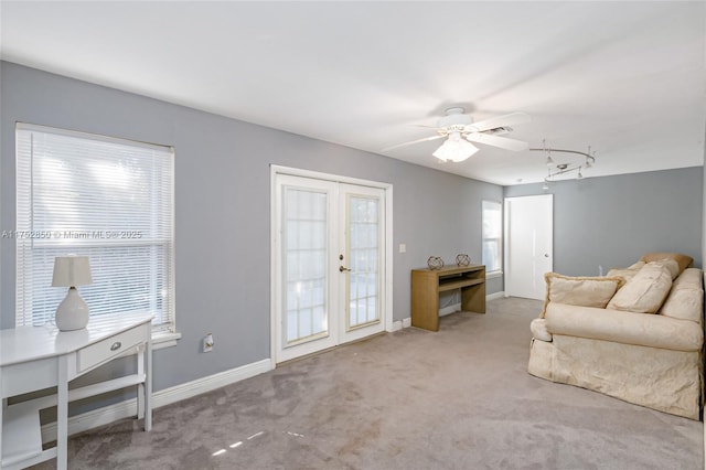 living area featuring carpet floors, visible vents, a ceiling fan, baseboards, and french doors