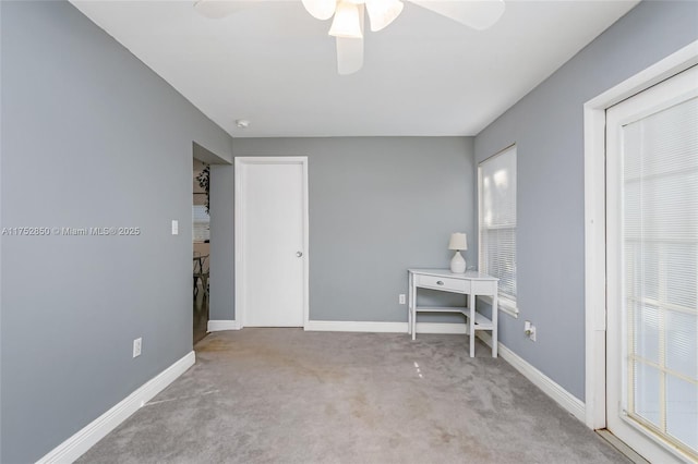 interior space featuring ceiling fan, carpet floors, and baseboards