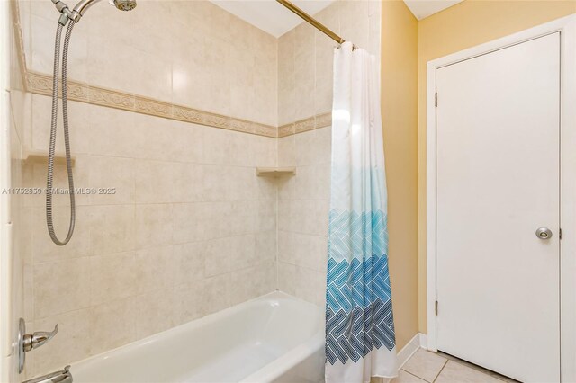 bathroom with tile patterned floors and shower / bath combo with shower curtain