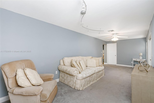 living room featuring baseboards, a ceiling fan, visible vents, and carpet