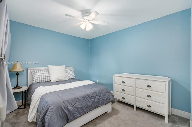 carpeted bedroom with baseboards and ceiling fan