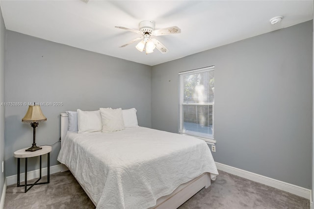 carpeted bedroom featuring baseboards and ceiling fan