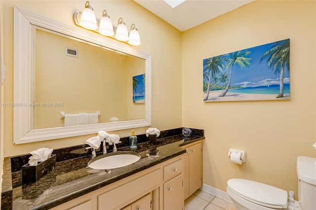 bathroom with toilet, baseboards, visible vents, tile patterned flooring, and vanity