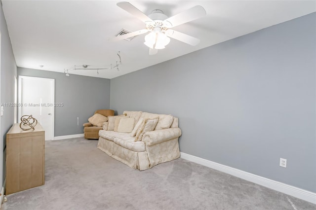 sitting room with track lighting, ceiling fan, baseboards, carpet flooring, and visible vents
