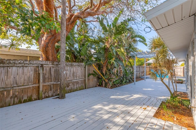 deck featuring a pergola and a fenced backyard