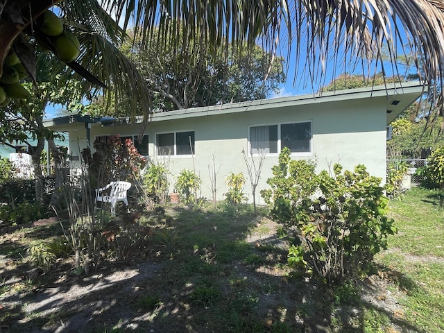 view of side of home featuring stucco siding