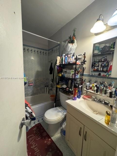 bathroom featuring toilet, tile patterned flooring, vanity, and bathing tub / shower combination