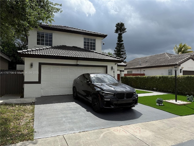 view of front of house with concrete driveway, a tile roof, fence, and stucco siding