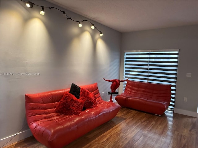 living room with baseboards and wood finished floors