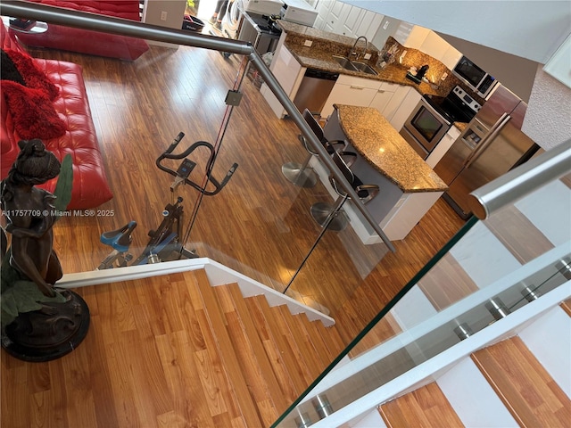 workout room with a sink and wood finished floors