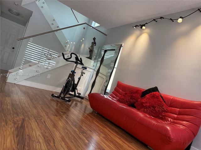 workout area featuring a textured ceiling and wood finished floors